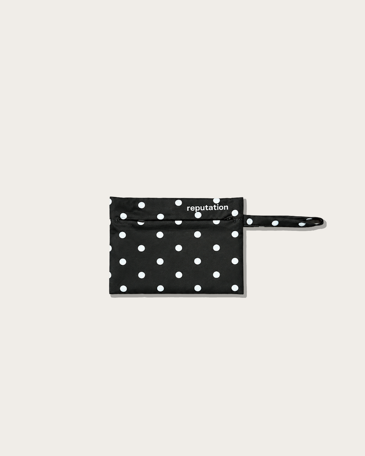 Reputation Polka Dots swimwear packaging pouch in black, flat lay