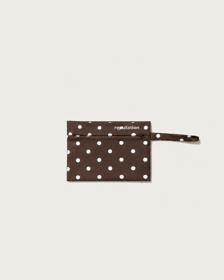 Reputation Polka Dots swimwear packaging pouch in brown, alternate flat lay